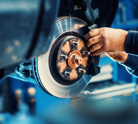 Close-Up of Mechanic Replacing Worn Out Brake Pads on Car