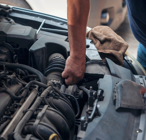 Close up Car Mechanic man hands repairing car auto repair shop. Man hands fixing machinery vehicle mechanical service. open vehicle hood checking up auto mobile. Vehicle Car maintenance engineer.