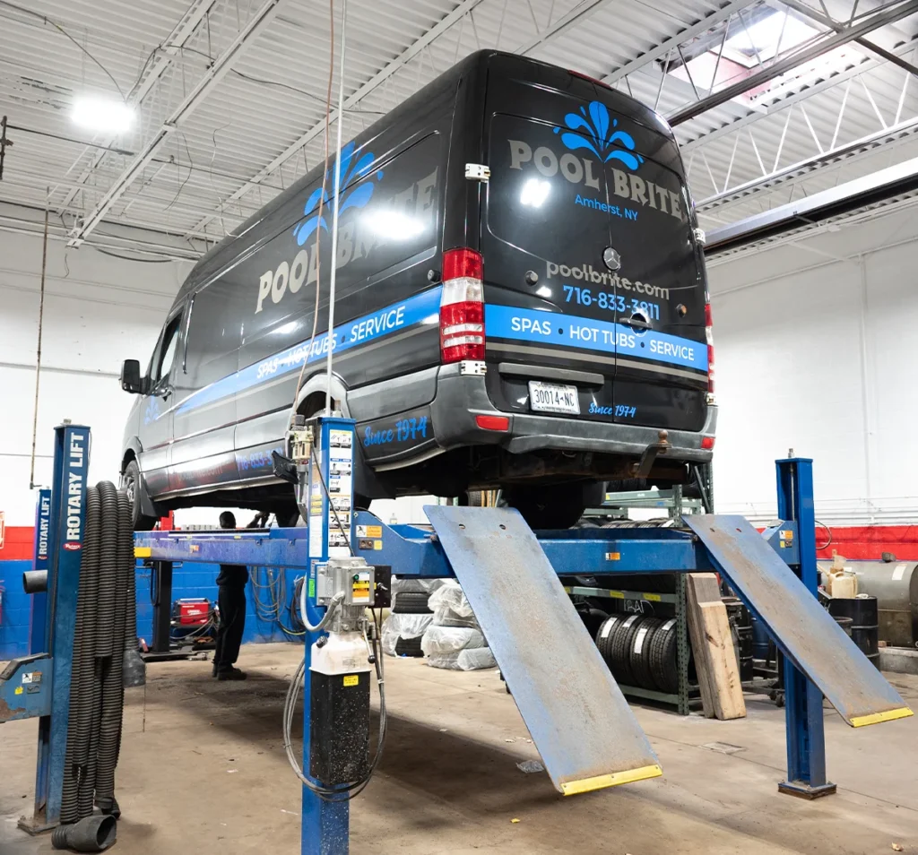 Fleet Maintenance & Repair Services auto repair in Buffalo, NY at Total Automotive. Image of a commercial service van lifted in a professional auto repair shop as technicians inspect the vehicle to ensure safe, reliable fleet performance.