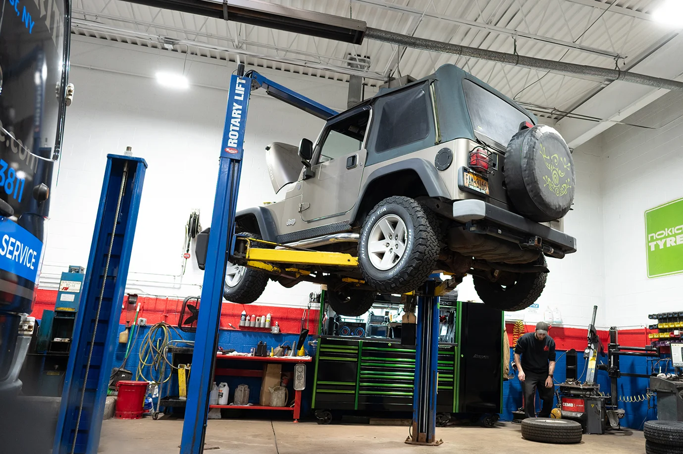 Total automotive garage, employee on the background