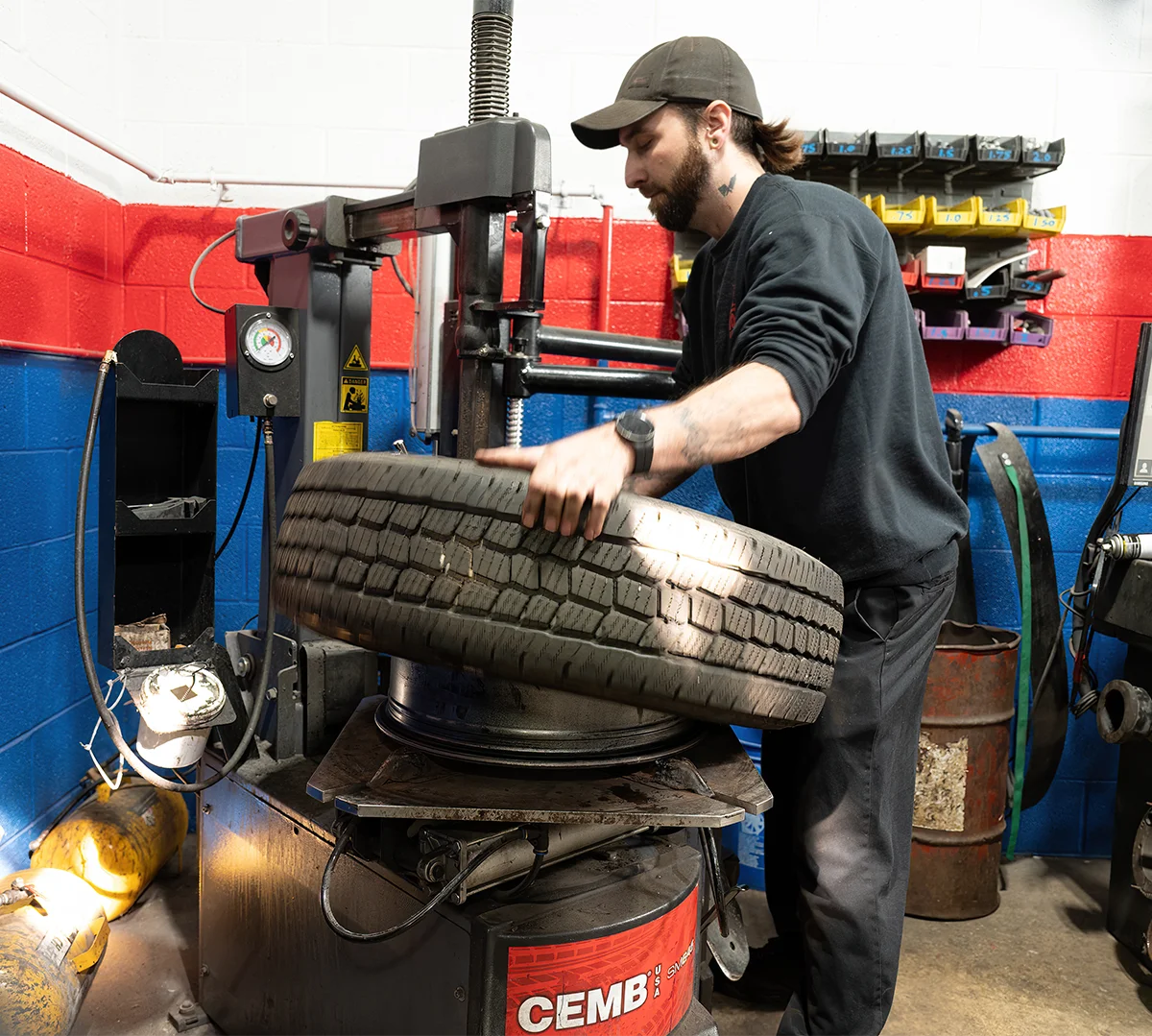 Total automotive mechanic repairing a tire