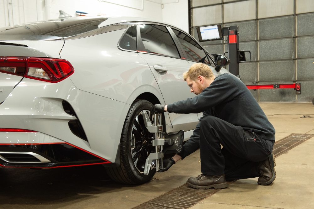 Preventive Wheel Alignment Inspection in Buffalo NY At Total Automotive. Mechanic performing wheel alignment on a vehicle