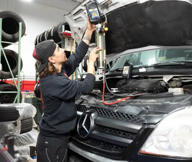 Person working on vehicle engine